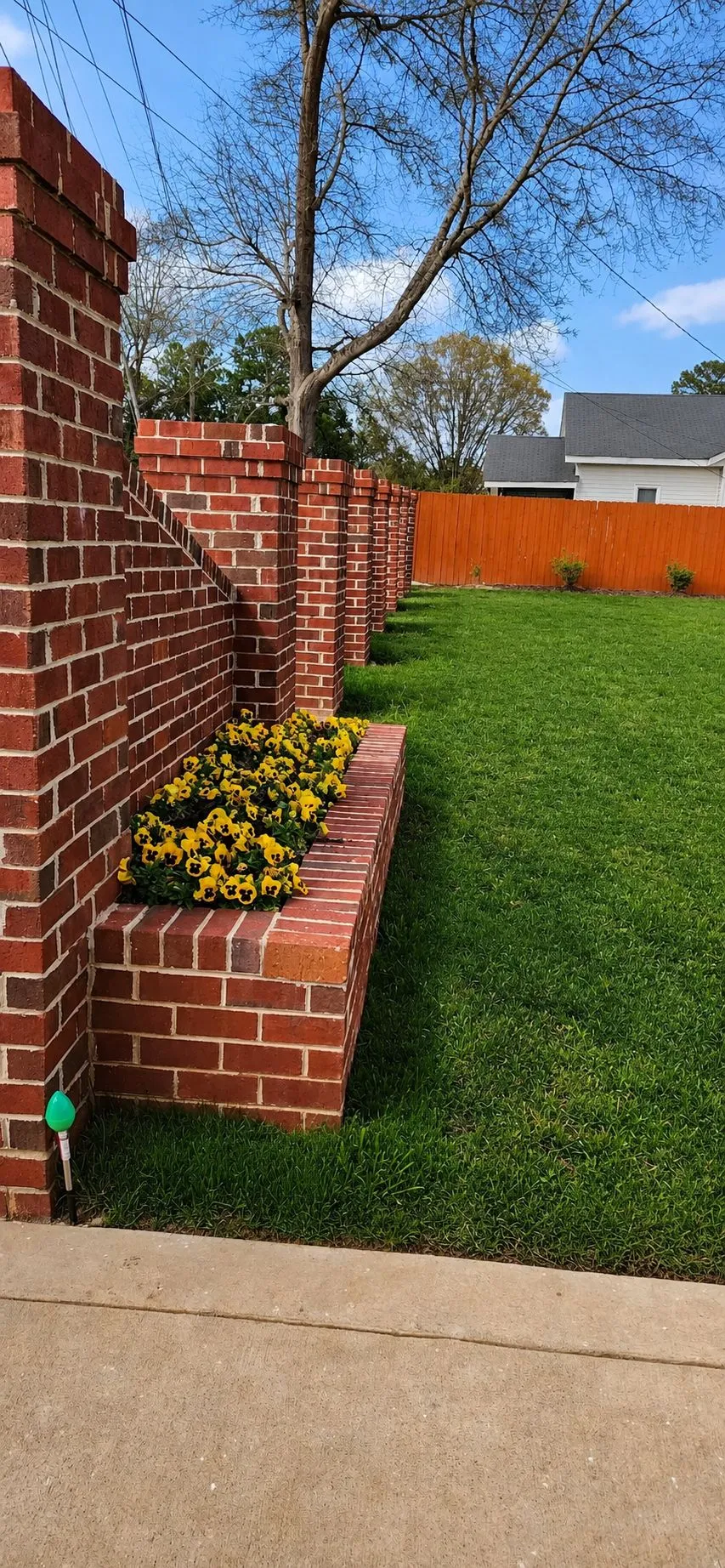 Seasonal Planter Wall Refresh: Brick Installation · Landscaping. Completed project by J & A Ground Maintenance.